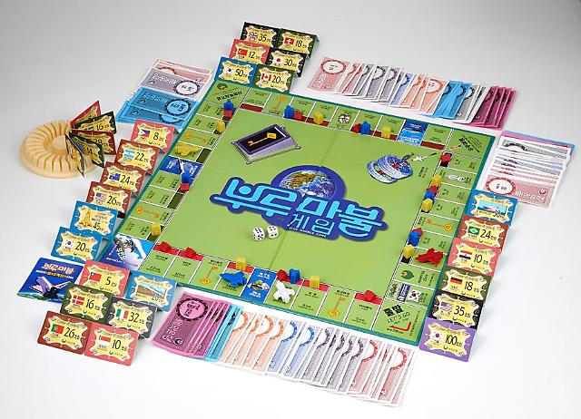 Organized components of Blue Marble board game, including gameboard, dices, golden key cards, buildings, spaceship, world cards, money pack, instruction